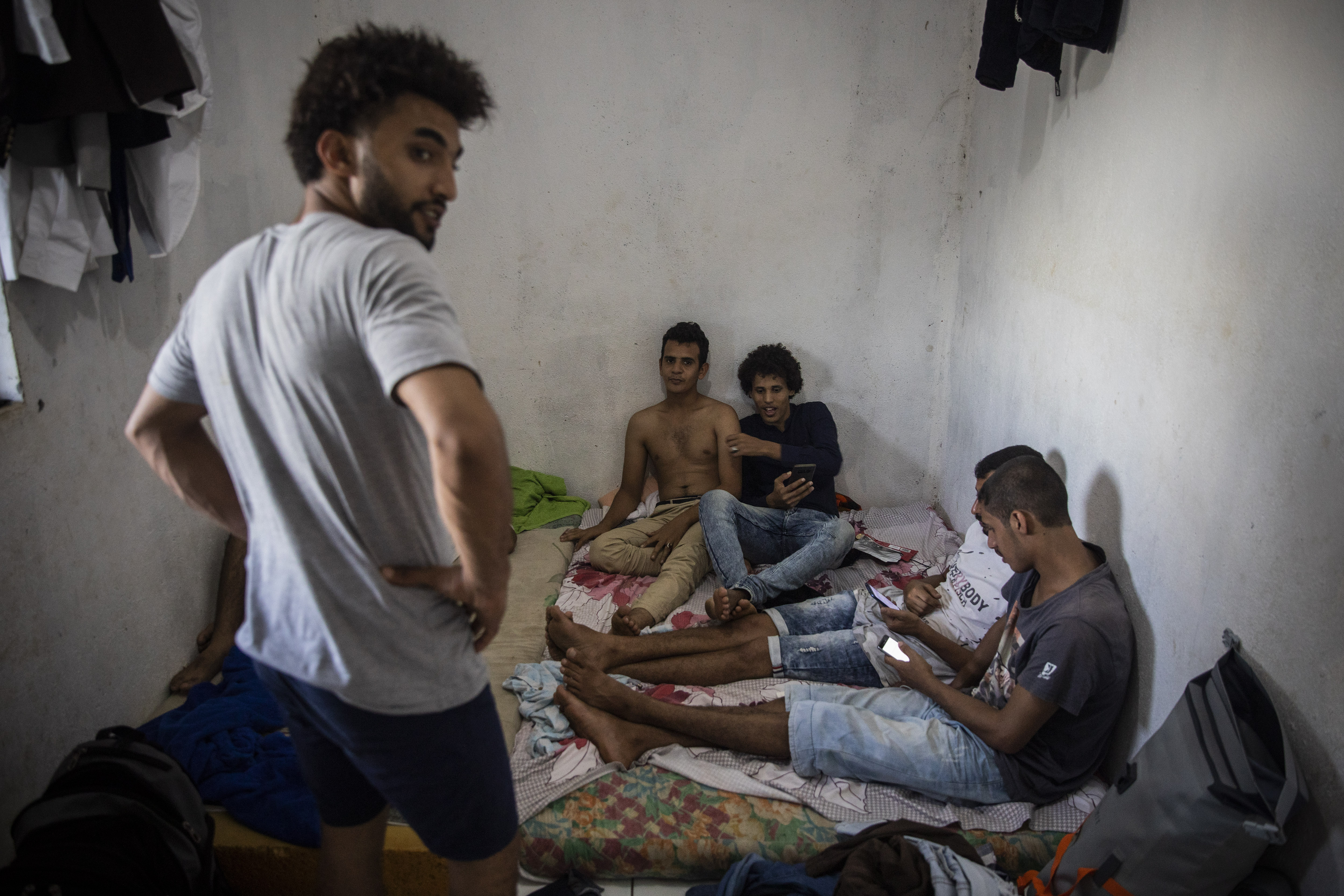 Yemeni youth kill time at a house where 6 of them reside, in the French island of Mayotte, waiting to receive documents and permission from the authorities to leave the island.
